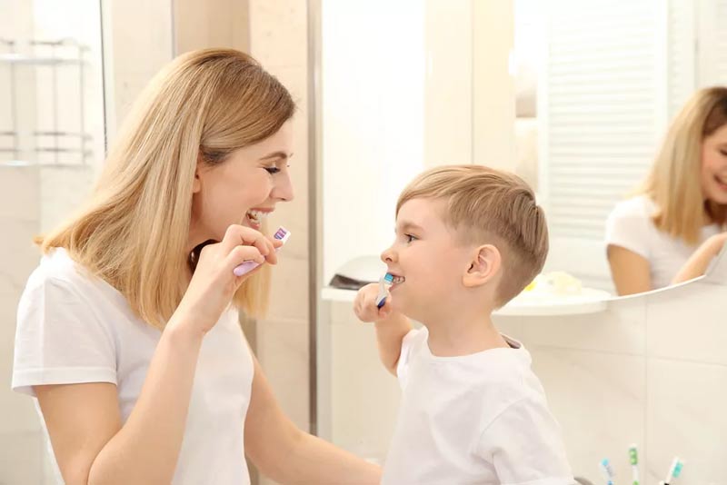 Brushing teeth mother and son